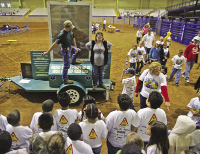 Children listen to a presenter during an agriculture safety day in Clovis, New Mexico.